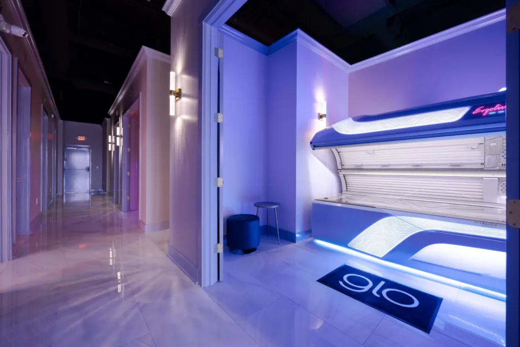 A luxurious Glo tanning salon location. A tanning bed is ready for use.