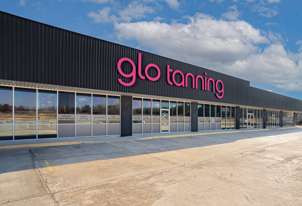 Parking lot and the storefront of a Glo Tanning salon in Paragould.