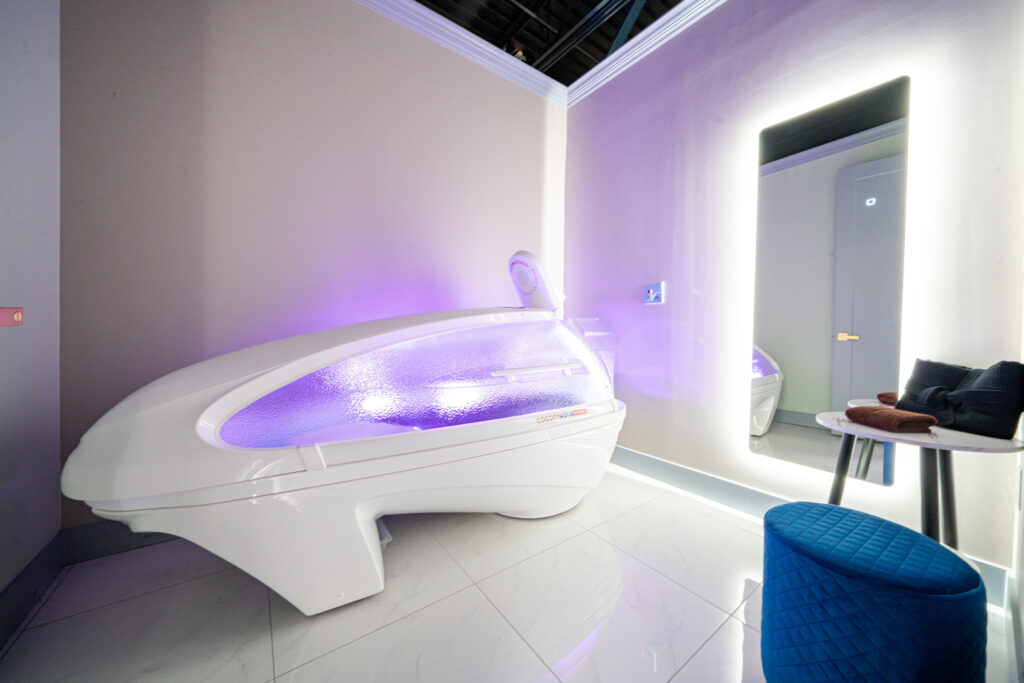 A closed wellness pod with purple lighting.