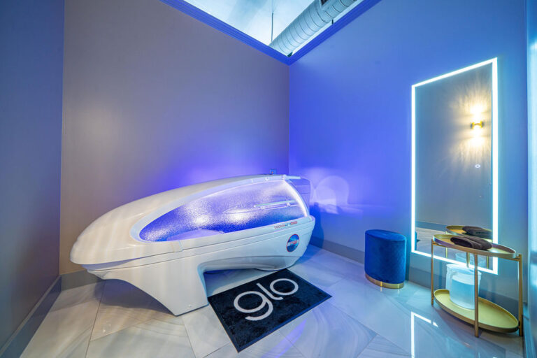 A closed wellness pod with blue lighting.