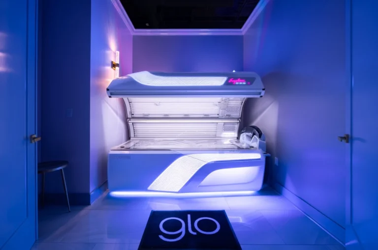 A UV tanning bed in a room with blue lighting.